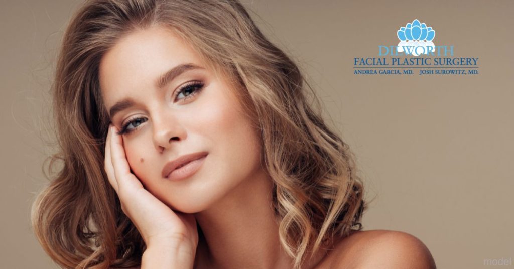 A woman with her hands on her face. (Model)