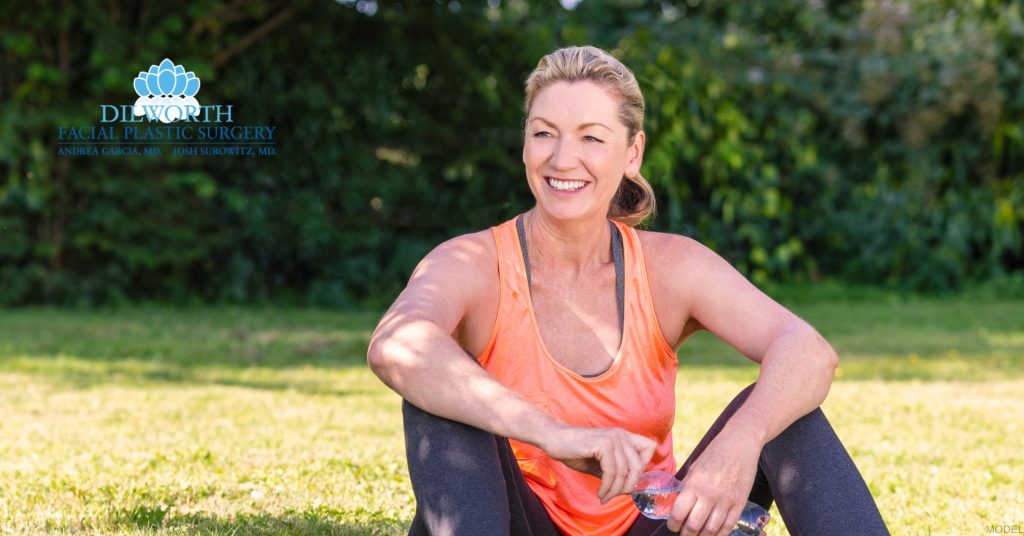 Woman sitting in a park after facelift recovery (Model)